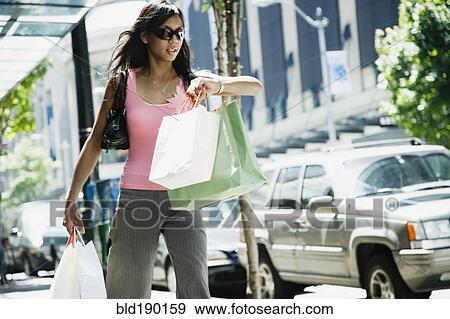 Stock Photo - African woman carrying shopping bags. Fotosearch