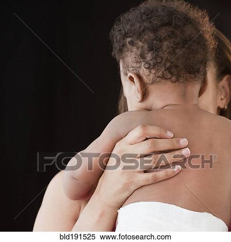Stock Photography - African woman holding baby. Fotosearch