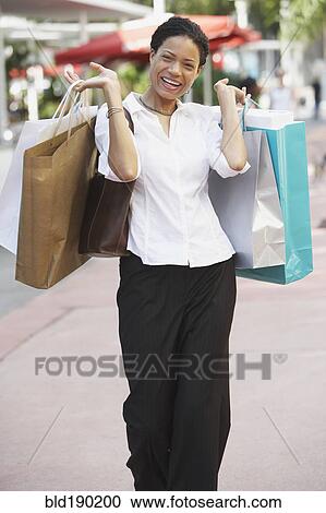 African woman holding shopping bags View Large Photo Image Stock Image - African woman holding shopping bags. Fotosearch
