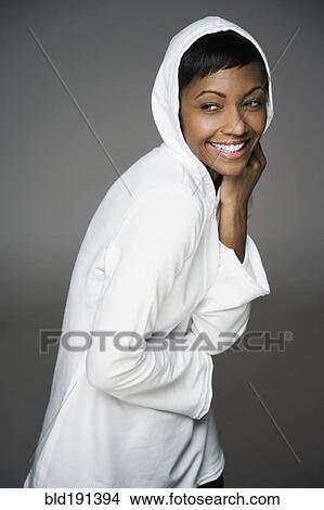 Picture - African woman in hooded shirt. Fotosearch