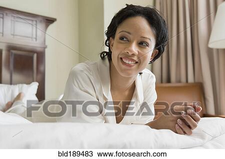African woman laying on bed View Large Photo Image Stock Image - African woman laying on bed. Fotosearch