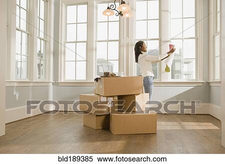Stock Photography - African woman moving house. Fotosearch