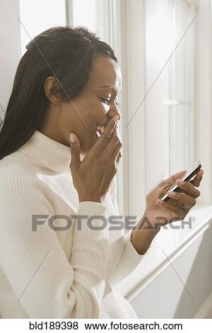 African woman using cell phone View Large Photo Image Stock Photo - African woman using cell phone. Fotosearch