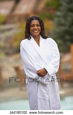 Stock Image - African woman wearing spa bathrobe. Fotosearch