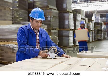 African worker taping boxes in warehouse View Large Photo Image Stock Photograph - African worker taping boxes in warehouse. Fotosearch