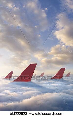 Airplane rudders above clouds View Large Photo Image Stock Image - Airplane rudders above clouds. Fotosearch