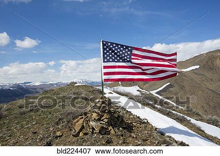 American flag waving from pile of rocks on mountain View Large Photo Image Stock Photo - American flag waving from pile of rocks on mountain. Fotosearch