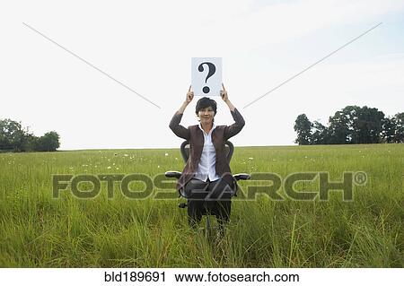 Asian businesswoman holding question mark in field View Large Photo Image Stock Image - Asian businesswoman holding question mark in field. Fotosearch