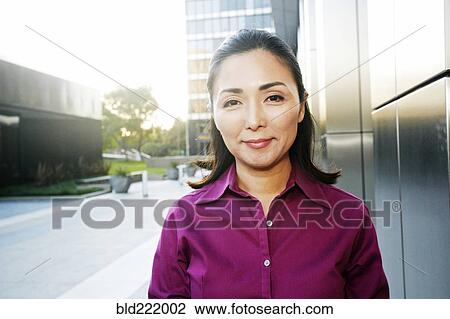 Asian businesswoman smiling outdoors View Large Photo Image Stock Image - Asian businesswoman smiling outdoors. Fotosearch