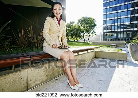 Asian businesswoman using digital tablet outdoors View Large Photo Image Stock Image - Asian businesswoman using digital tablet outdoors. Fotosearch