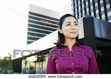 Picture - Asian businesswoman walking outdoors. Fotosearch