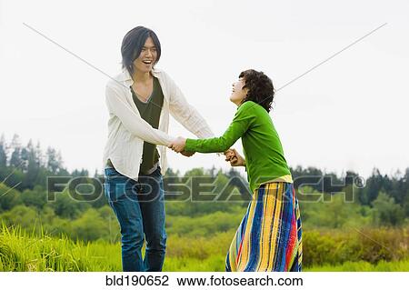 Stock Image - Asian couple holding hands. Fotosearch