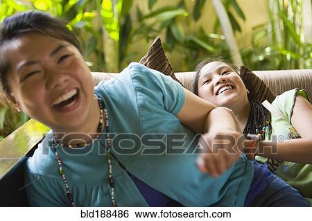 Asian friends laughing View Large Photo Image Stock Photograph - Asian friends laughing. Fotosearch