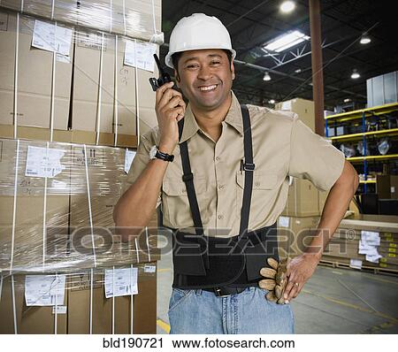 Stock Image - Asian man working in warehouse. Fotosearch