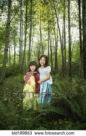 Asian sisters wearing costumes in woods View Large Photo Image Stock Image - Asian sisters wearing costumes in woods. Fotosearch