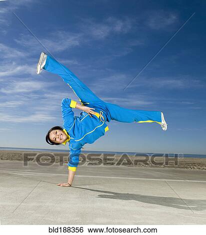 Asian woman balancing on one hand View Large Photo Image Stock Photograph - Asian woman balancing on one hand. Fotosearch