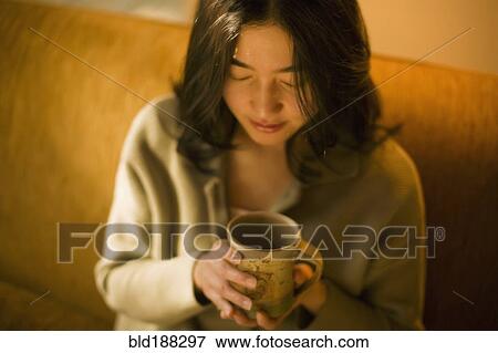 Stock Photo - Asian woman drinking tea. Fotosearch
