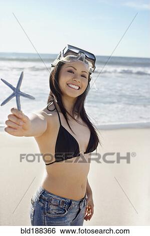 Asian woman holding starfish View Large Photo Image Stock Photograph - Asian woman holding starfish. Fotosearch