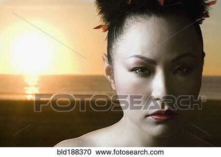Asian woman in front of sunset View Large Photo Image Stock Image - Asian woman in front of sunset. Fotosearch