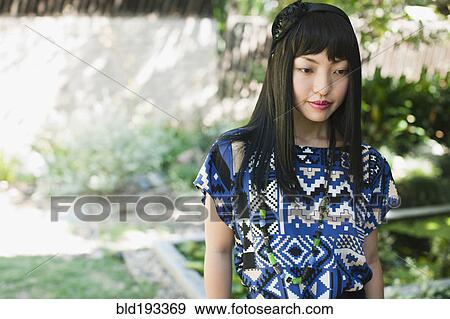 Stock Photo - Asian woman in glamorous dress and hat. Fotosearch