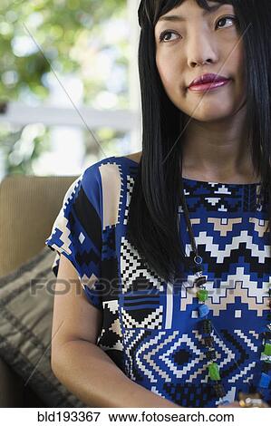 Stock Photo - Asian woman in patterned dress. Fotosearch