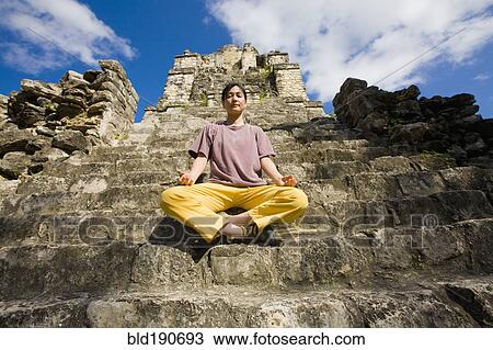 Asian woman meditating on temple ruins View Large Photo Image Stock Image - Asian woman meditating on temple ruins. Fotosearch