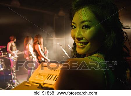 Asian woman playing keyboard onstage View Large Photo Image Stock Photo - Asian woman playing keyboard onstage. Fotosearch