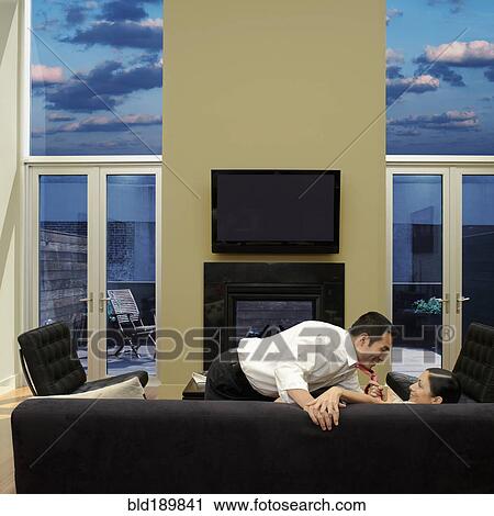 Asian woman pulling husband down onto sofa View Large Photo Image Stock Image - Asian woman pulling husband down onto sofa. Fotosearch
