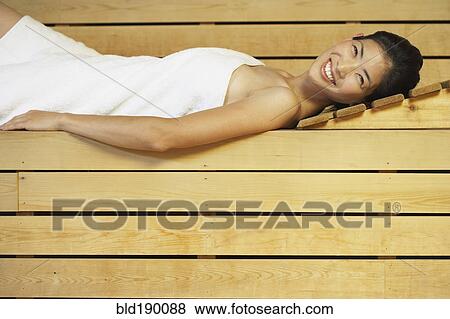 Stock Photo - Asian woman relaxing in sauna. Fotosearch