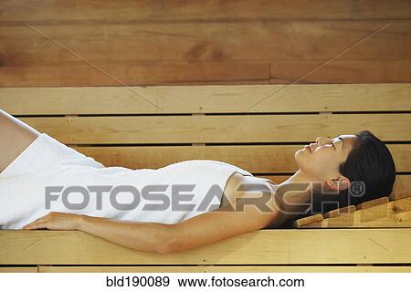 Stock Photo - Asian woman relaxing in sauna. Fotosearch