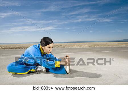 Picture - Asian woman stretching. Fotosearch