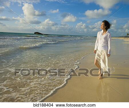 Asian woman walking on beach View Large Photo Image Picture - Asian woman walking on beach. Fotosearch