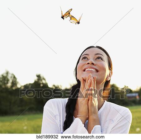 Asian woman watching butterflies in meadow View Large Photo Image Stock Image - Asian woman watching butterflies in meadow. Fotosearch