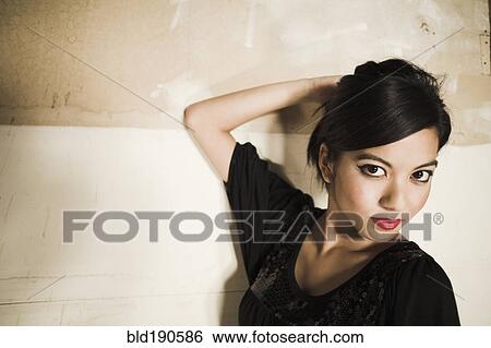Stock Photograph - Asian woman with hand on head. Fotosearch