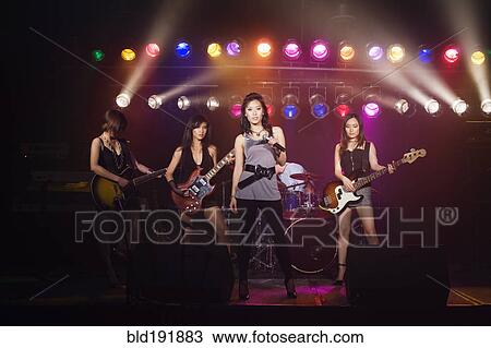 Asian women singing and playing electric guitar onstage View Large Photo Image Stock Image - Asian women singing and playing electric guitar onstage. Fotosearch