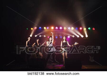 Asian women singing and playing electric guitar onstage View Large Photo Image Stock Photo - Asian women singing and playing electric guitar onstage. Fotosearch