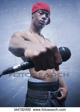 Back lit African singer holding microphone View Large Photo Image Stock Image - Back lit African singer holding microphone. Fotosearch