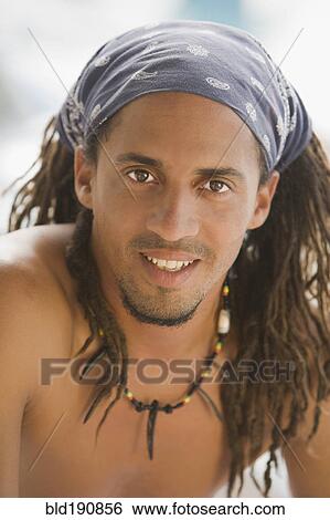 Stock Photograph - Bare chested Hispanic man in headscarf. Fotosearch