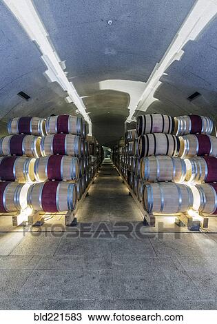 Barrels of wine aging in wine cellar View Large Photo Image Stock Image - Barrels of wine aging in wine cellar. Fotosearch