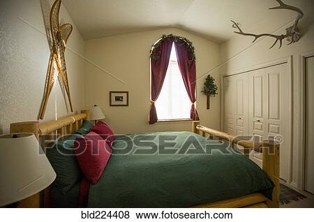 Bed in rustic bedroom View Large Photo Image Stock Photo - Bed in rustic bedroom. Fotosearch