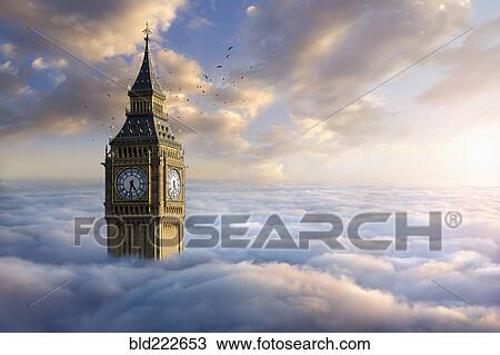 Stock Image - Birds flying around clock tower above clouds. Fotosearch