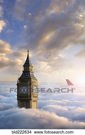 Birds flying around clock tower near airplane rudder above clouds View Large Photo Image Picture - Birds flying around clock tower near airplane rudder above clouds. Fotosearch