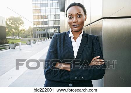 Stock Image - Black businesswoman smiling outdoors. Fotosearch