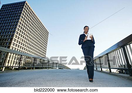Stock Image - Black businesswoman using digital tablet outdoors. Fotosearch
