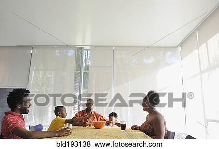 Stock Photo - Black family eating at dining room table. Fotosearch