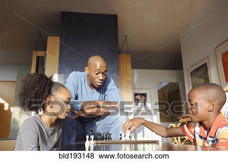 Black father watching children play chess View Large Photo Image Stock Photo - Black father watching children play chess. Fotosearch