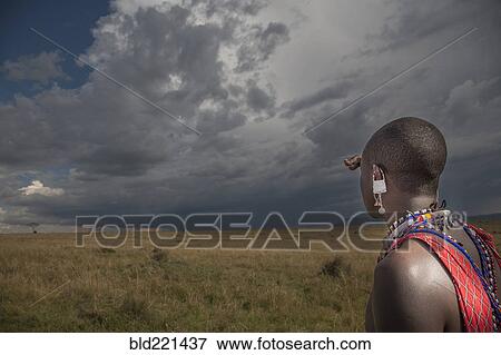 Stock Photo - Black man in traditional clothing admiring view. Fotosearch