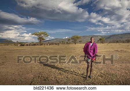 Black man in traditional clothing standing in remote field View Large Photo Image Stock Photograph - Black man in traditional clothing standing in remote field. Fotosearch
