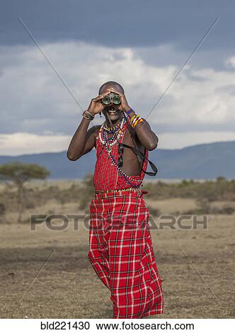 Black man in traditional clothing using binoculars View Large Photo Image Stock Image - Black man in traditional clothing using binoculars. Fotosearch