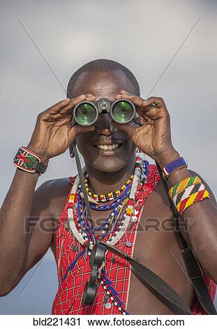 Black man in traditional clothing using binoculars View Large Photo Image Stock Image - Black man in traditional clothing using binoculars. Fotosearch